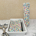 Flannel reusable paper towels. This pictures shows possible display options on Kitchen counter. One group is folded in a basket and the other group rolled on a cylinder. Cotton fabric has a colorful confetti dot pattern on white background. 