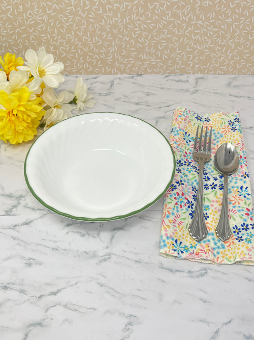 Flannel reusable paper towels. this pictures shows one towel in a place setting.   Cotton fabric has a ditzy floral print pattern of tiny colorful flowers on a white background.