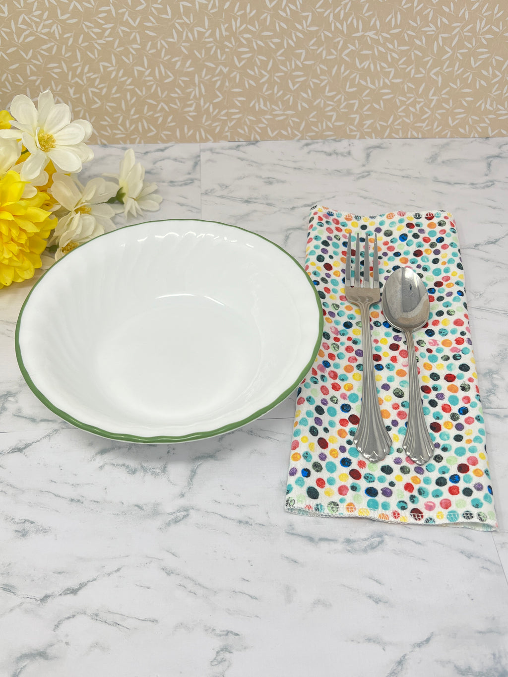 Flannel reusable paper towels. This pictures shows possible use as a napkin in a place setting.  Cotton flannel fabric has a colorful confetti dot pattern on a white background