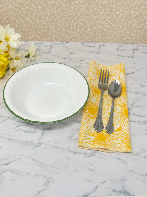 Flannel reusable paper towels. This pictures shows possible use options as a napkin in a table place setting. Cotton fabric has a large overlapping  sketch of yellow daisies 